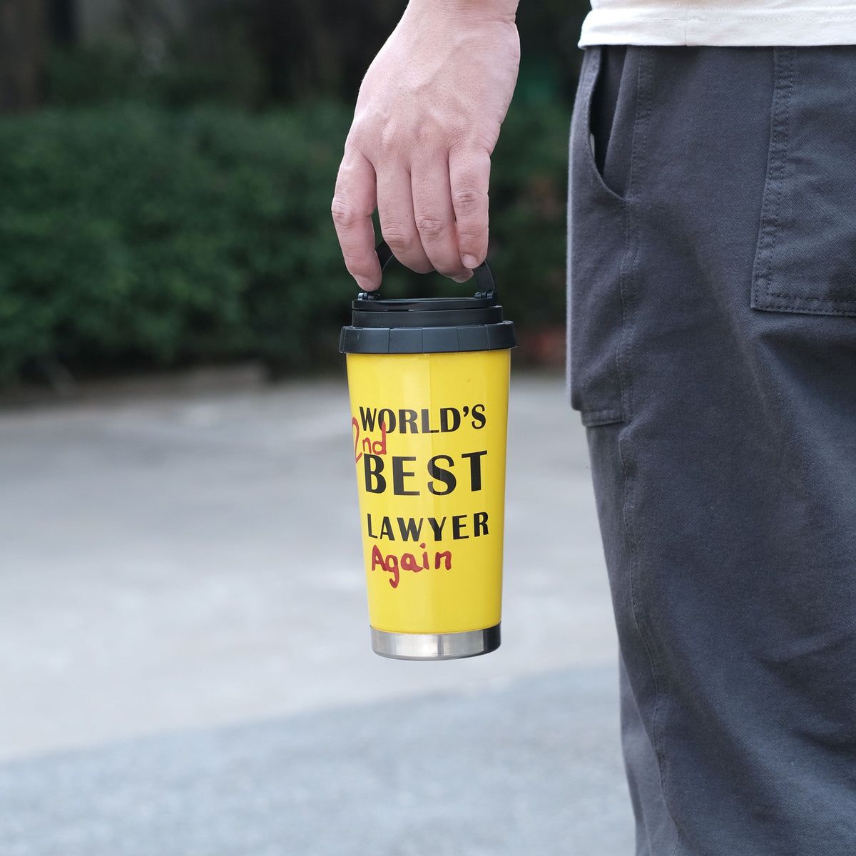 Sunset yellow lawyer mug carried by its lid handle