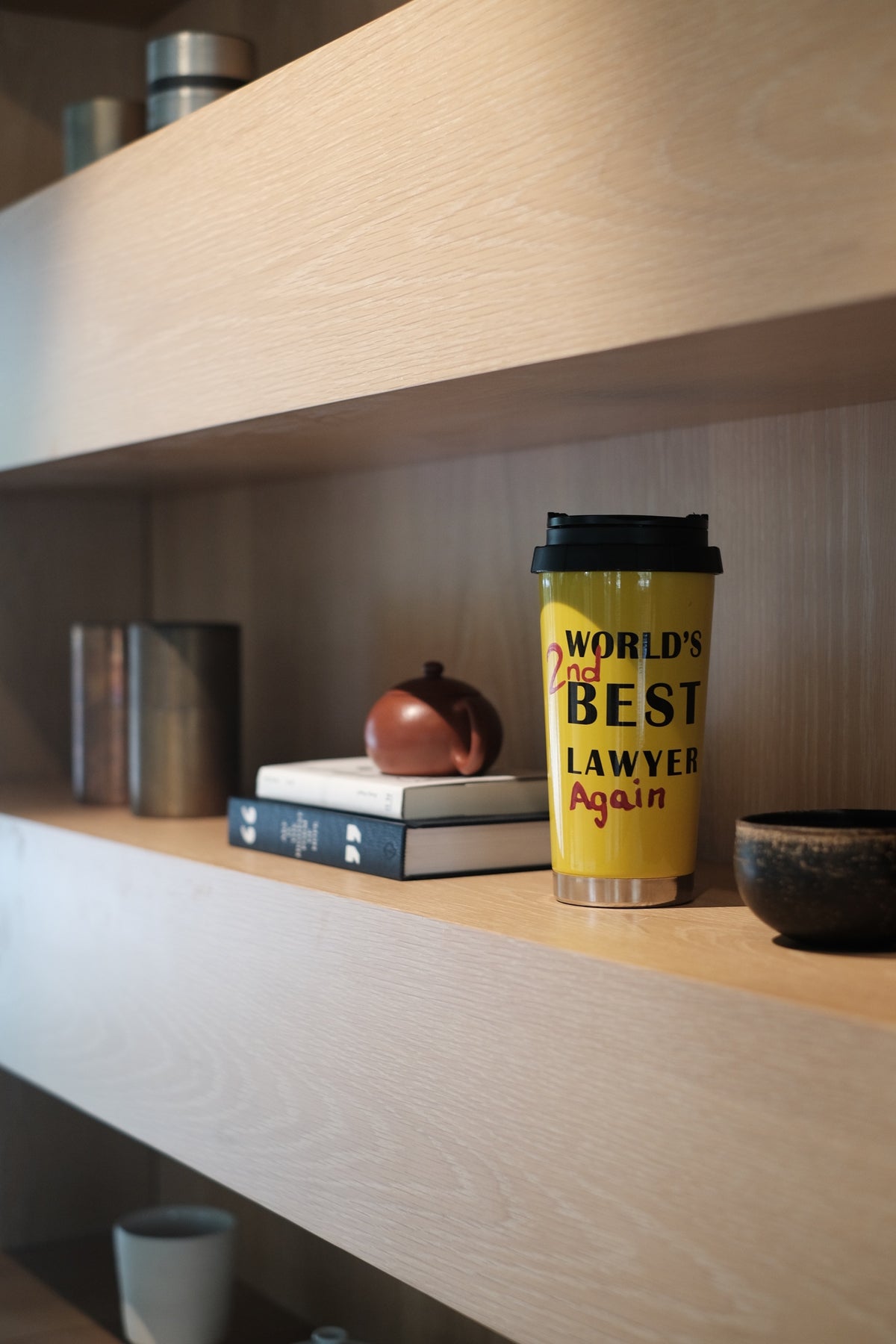 Sunset yellow lawyer mug displayed on a shelf